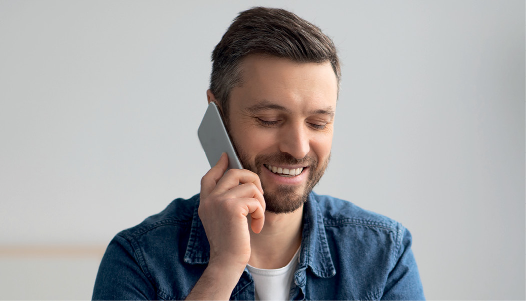 Man with beard talking on mobile phone