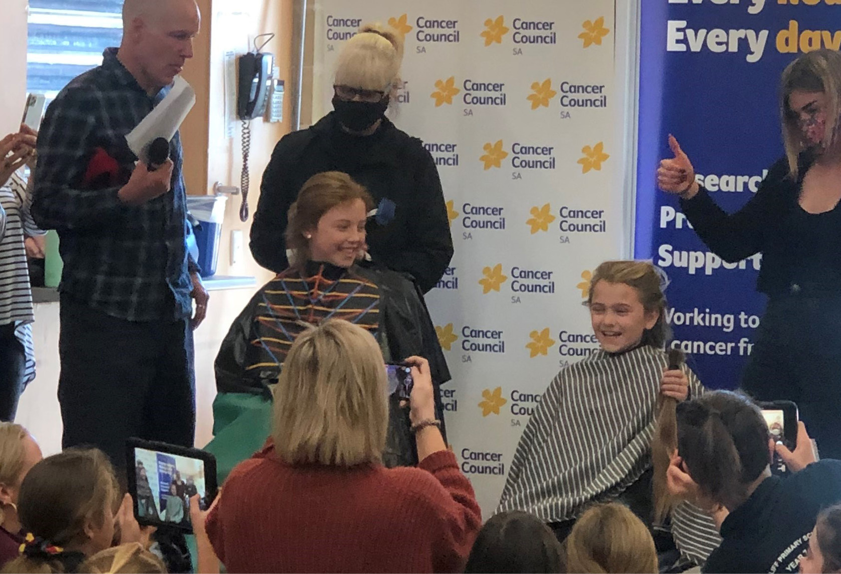 Group of kids cutting hair for cancer fundraiser