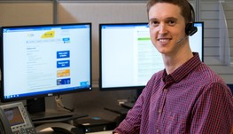 A man working on the computer answering calls