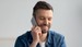 Man with beard talking on mobile phone