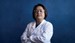 Woman of asian descent in white lab coat