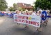 Marilyn Jetty swim participants holding large banner reading 'Brighton Prefers Blondes'